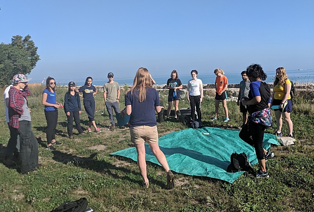 Integrated Sciences, Life Sciences and Arts and Science students gather along the shoreline of Hamilton Harbour to take part in Mischief in the Harbour.