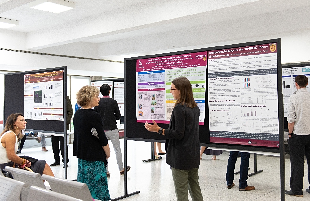 Students share their projects with alumni, and faculty and staff – past and present – at a poster session in Ivor Wynne Centre.