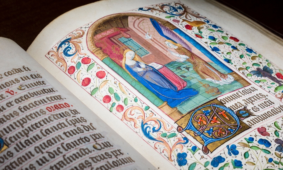 Image of the medieval manscript, the book of hours, featuring illuminated text.