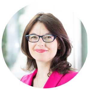 A headshot of Dawn Bowdish. She is wearing glasses, a fuschia blazer and is smiling at the camera. 