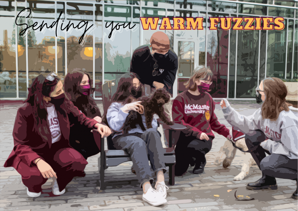 A Valentines postcard that reads 'sending you warm fuzzies' and shows a group of McMaster students playing with two therapy dogs
