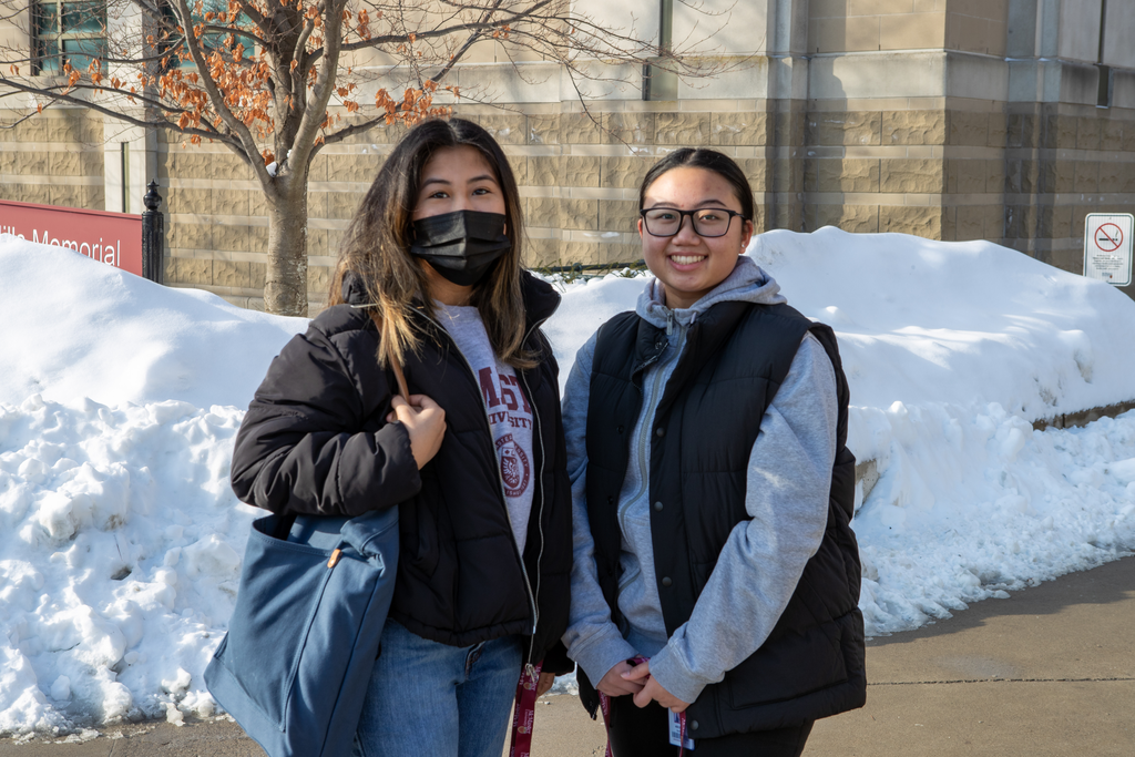 Two students stand beside each other on McMaster's campus. 