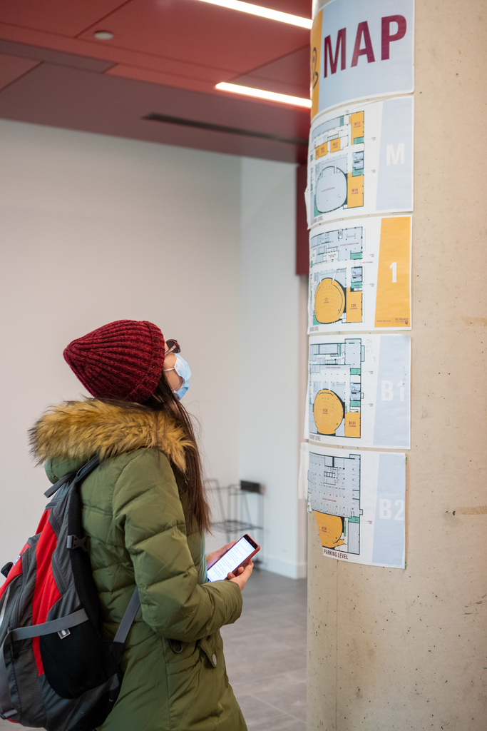 A McMaster student looks up at a map