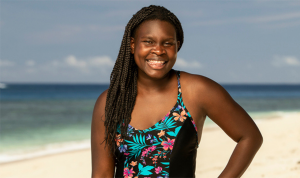 Maryanne Oketch standing on a beach smiling at the camera