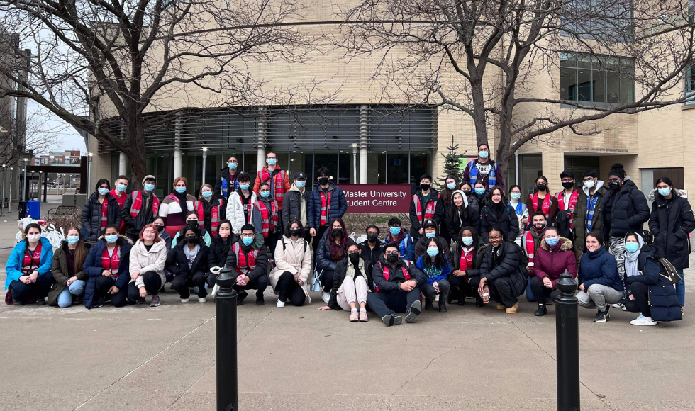 A group of students posing for a picture on McMaster's campus
