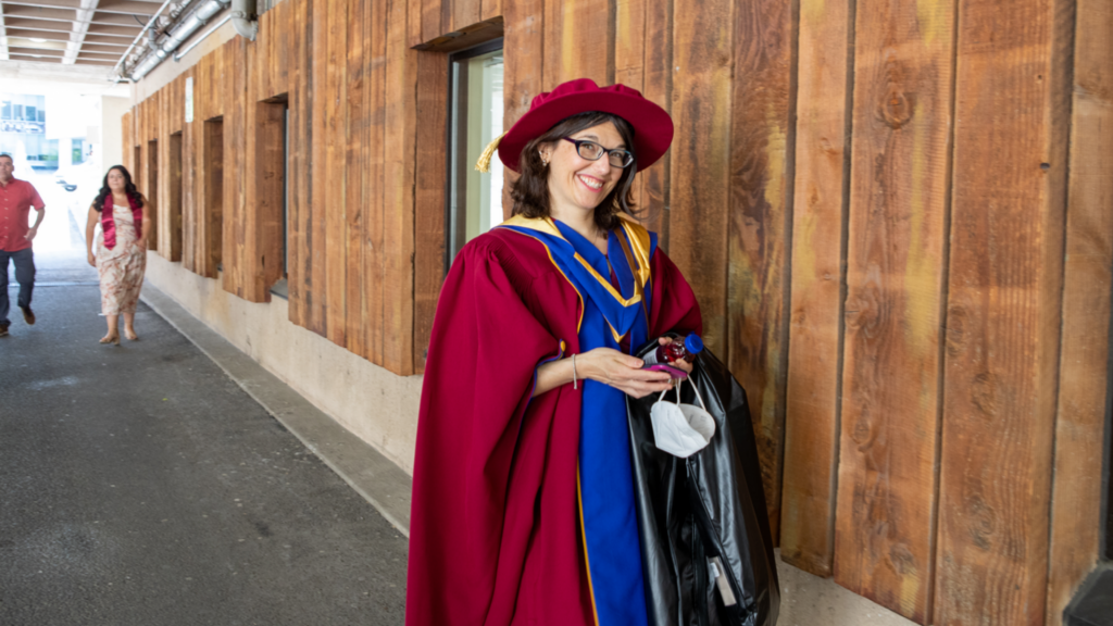 Professor Dawn Bowdish wearing her convocation regalia and smiling at the camera