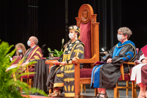 Santee Smith, wearing the chancellor's robes while sitting onstage during convocation