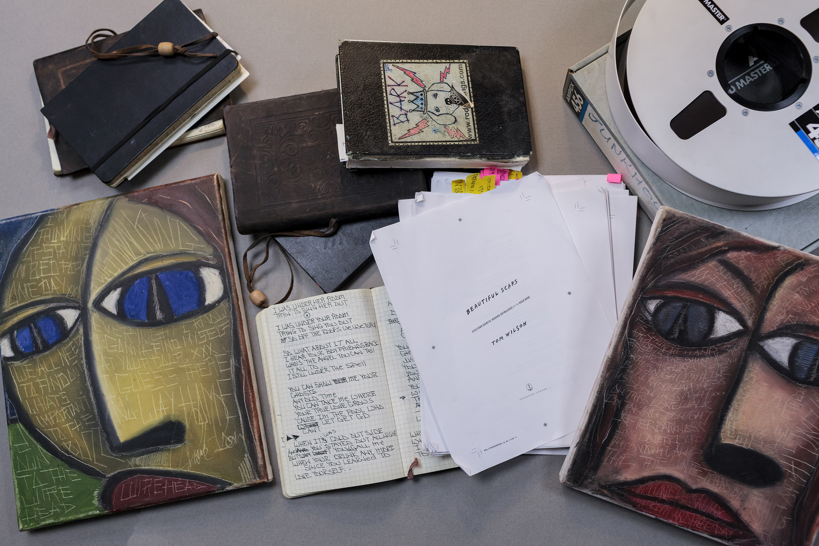 Paintings, files and notebooks on a table