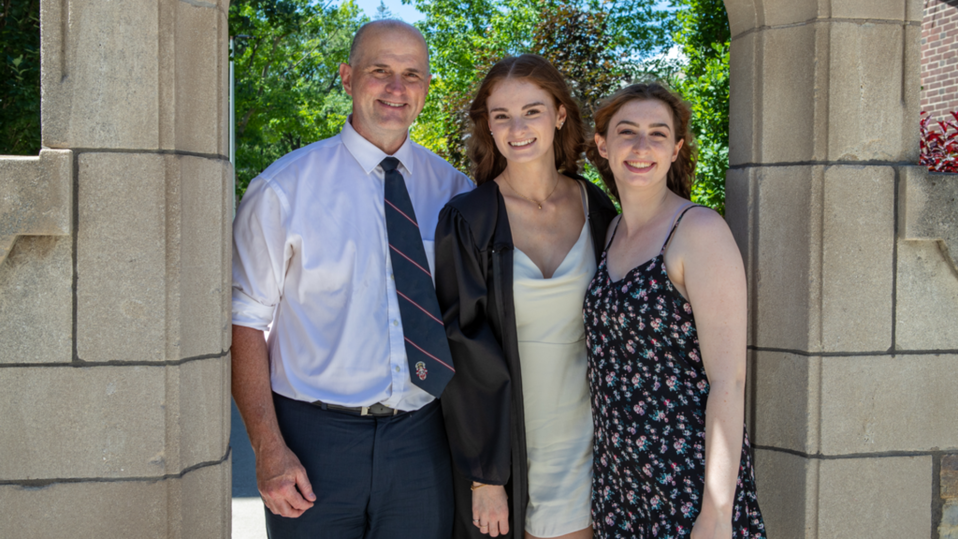 Catherine Shrimpton poses for a photo with her father and sister under the Edwards Arch