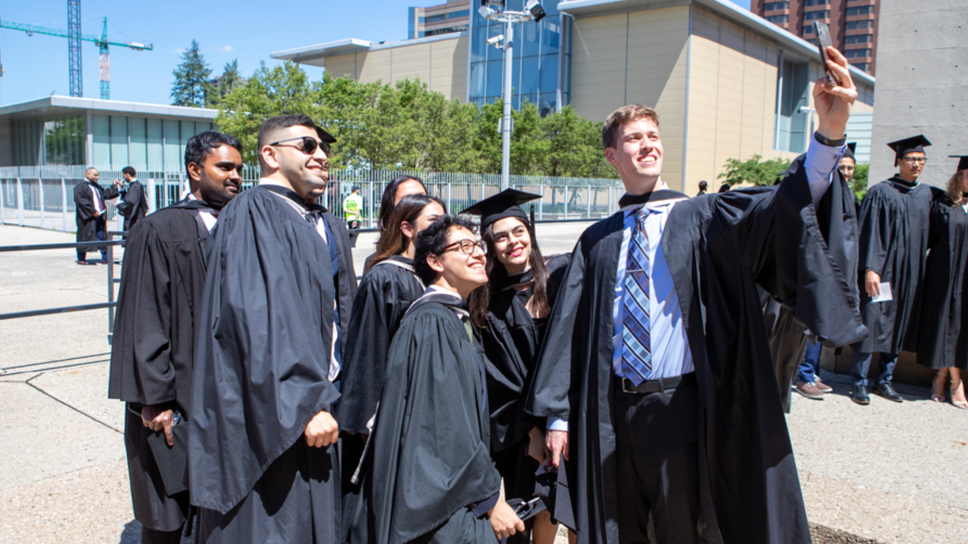 A group of engineers in their graduation robes pose for a selfie