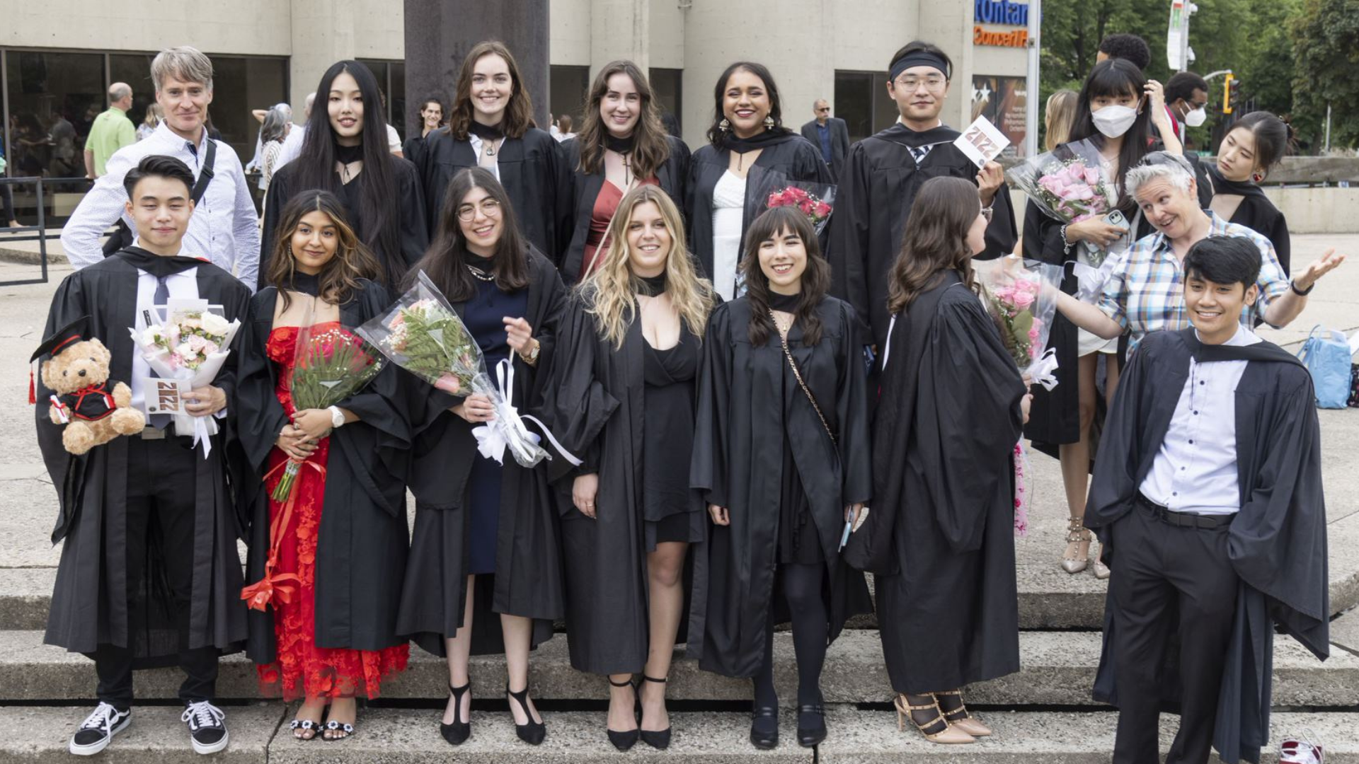 A group of media arts graduates posing for a photo