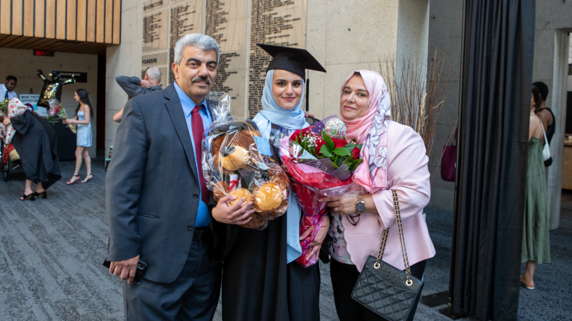 Master of Public Policy in Digital Society graduate Sara Daas poses for a photo with her parents