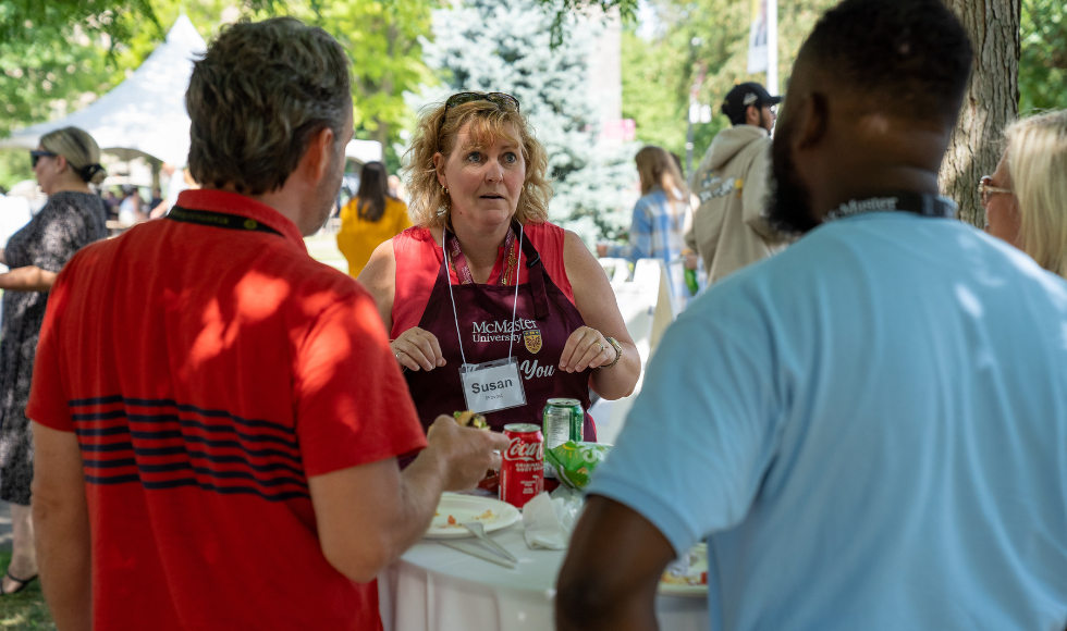 Susan Tighe speaks with staff at BBQ