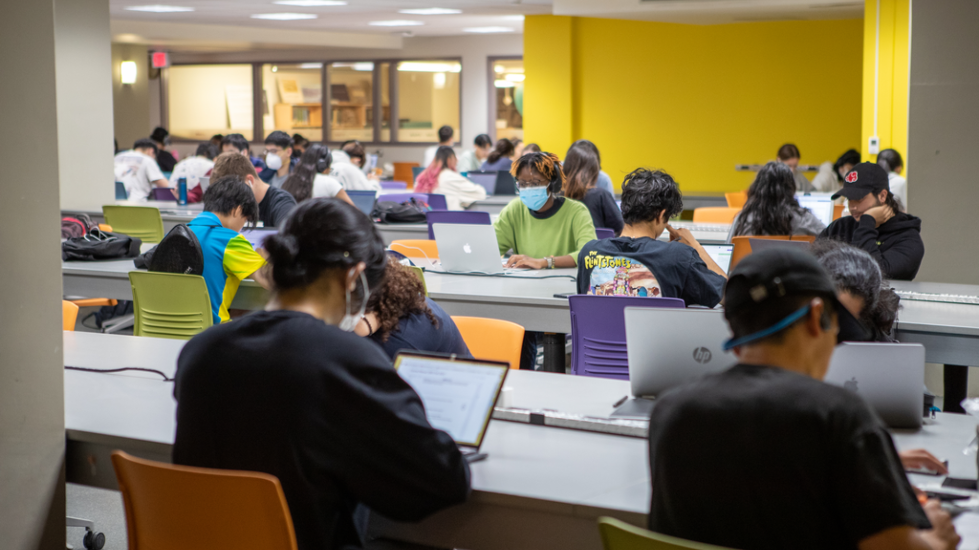 Students seated studying inside McMaster's Mills Library 