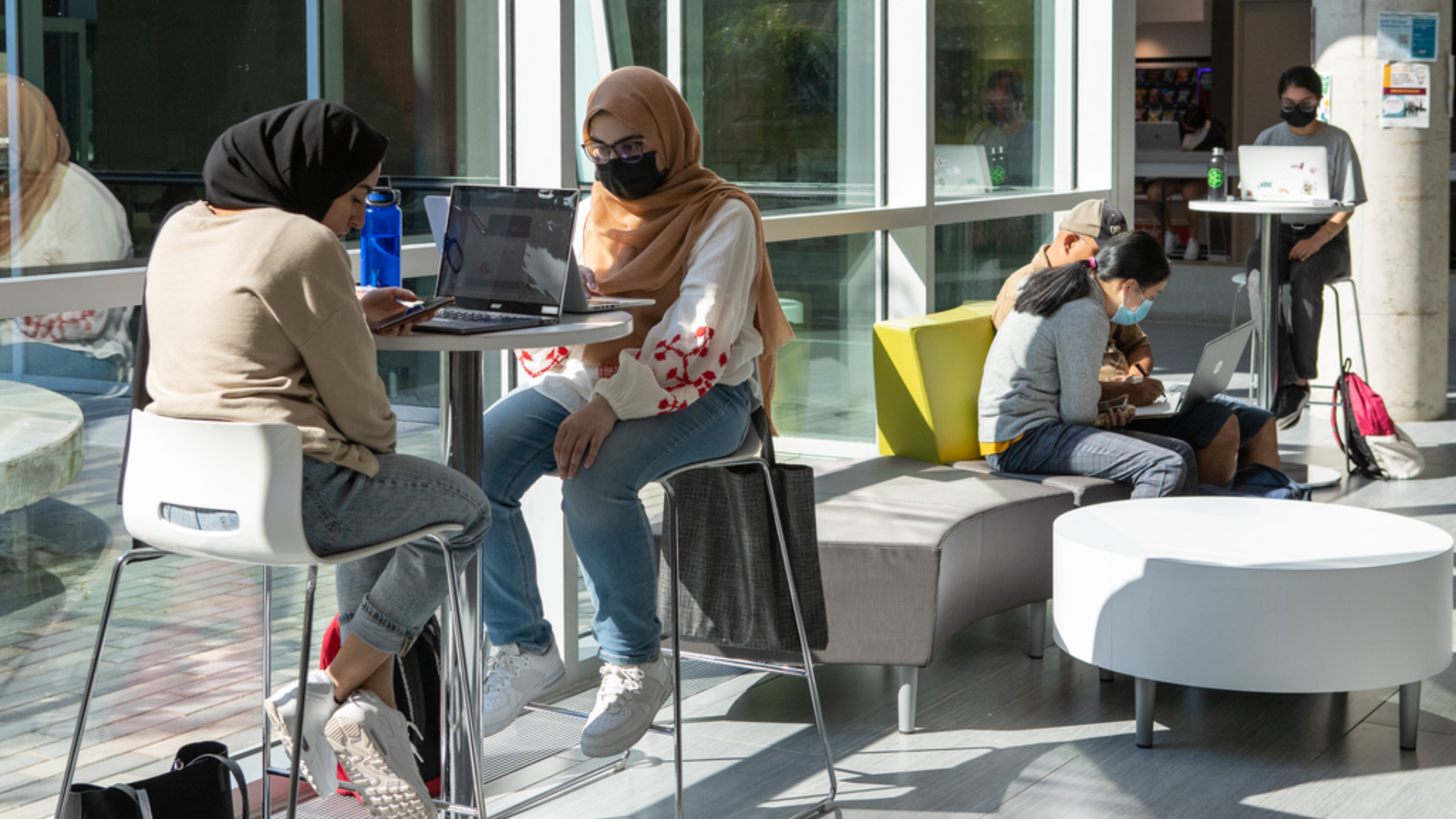 Several students seated studying inside LR Wilson Hall