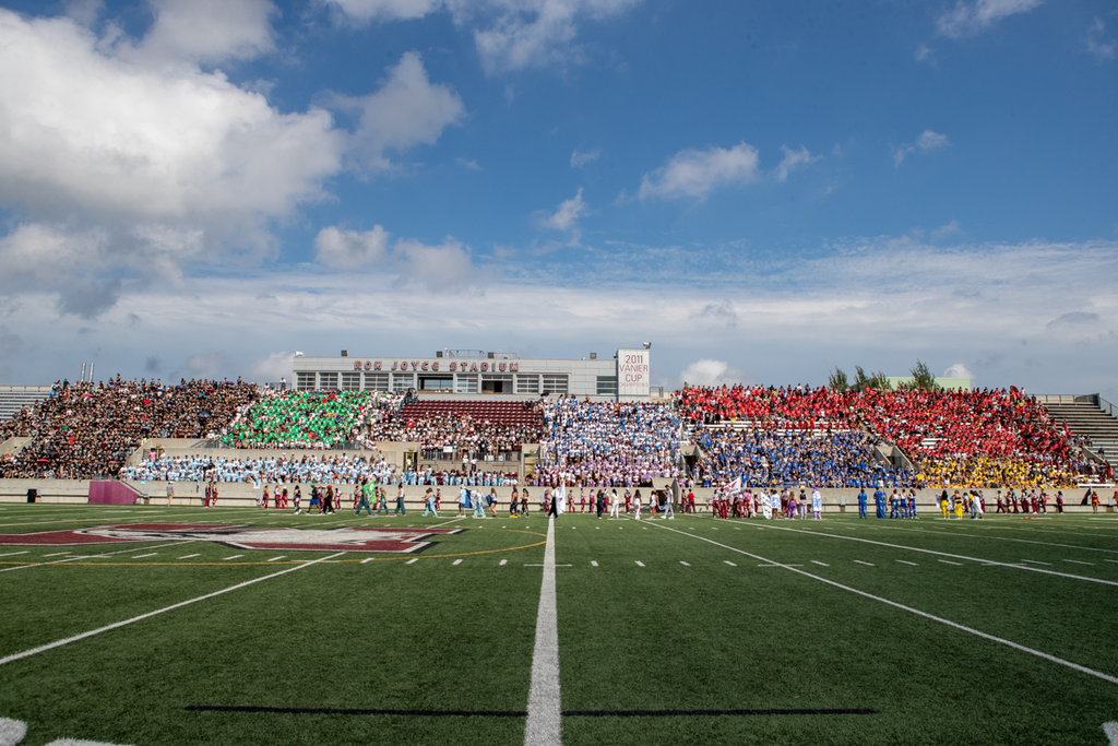 McMaster's Ron Joyce Stadium full of students wearing colours that correspond to their faculty 