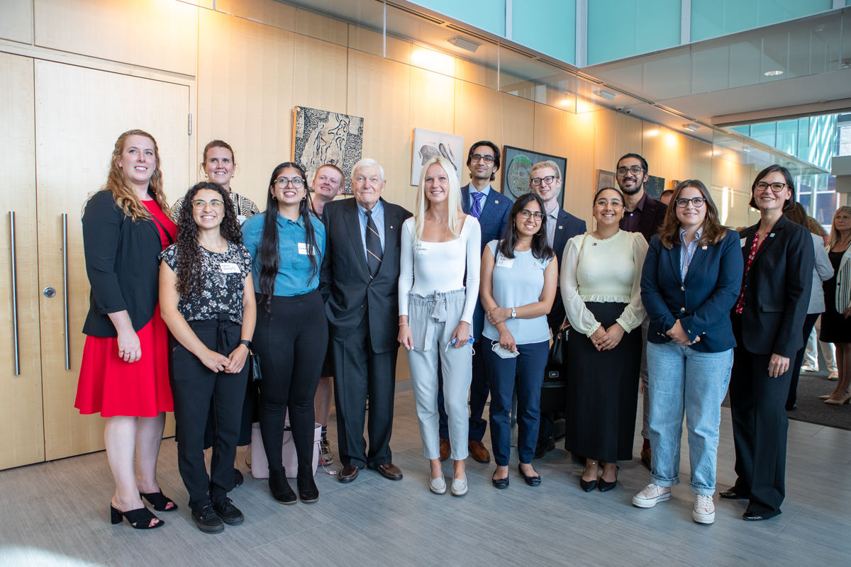 A group of McMaster students and LR Wilson stand posing for a photo