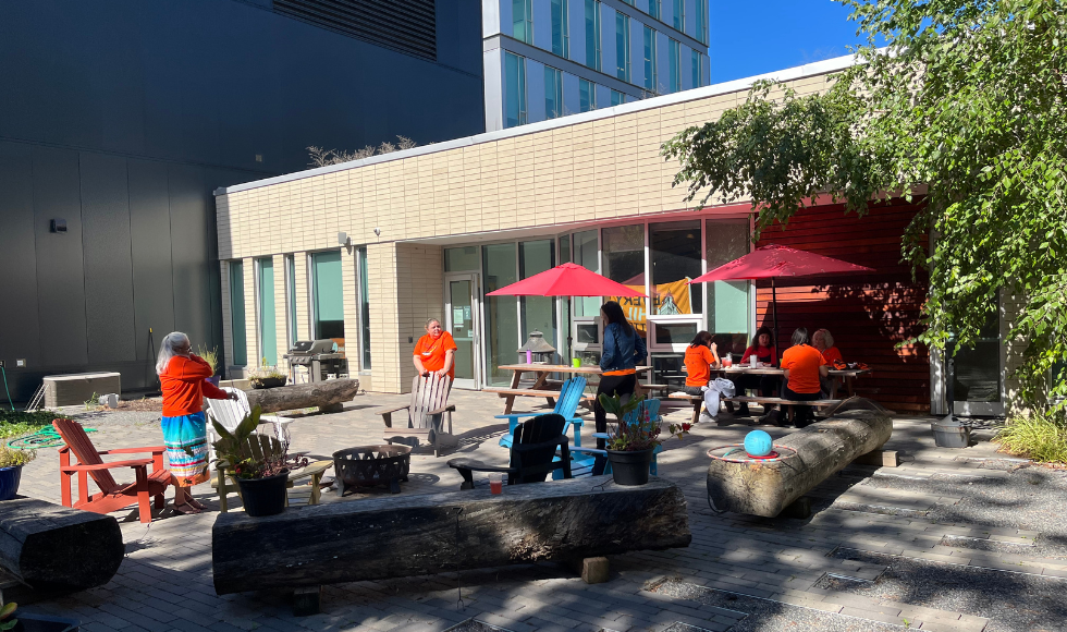 People in Orange shirts eating outdoors