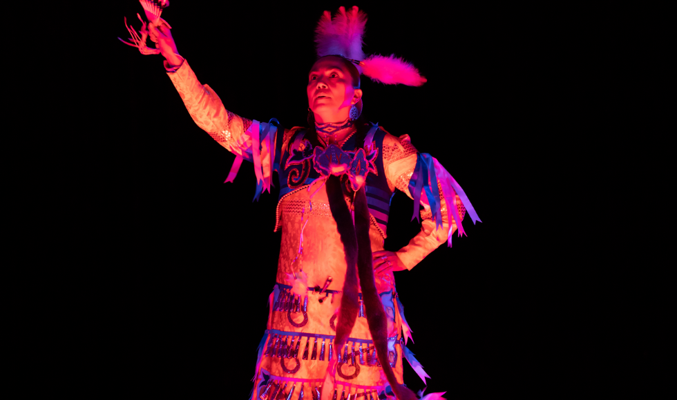 A dancer raising one arm during an interpretive dance performance