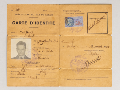 A piece of paper that has creases from being folded and features a headshot of Keith Patrick. It reads, 'carte d'identite' and has french typed and handwritten text on it. 