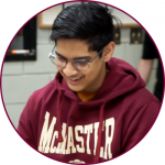 A student in a McMaster hooded sweatshirt inside a maroon-lined circle