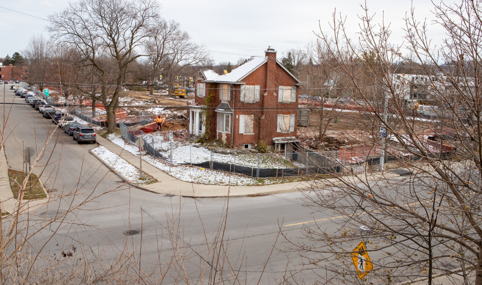 A partially demolished house sitting in a construction site.