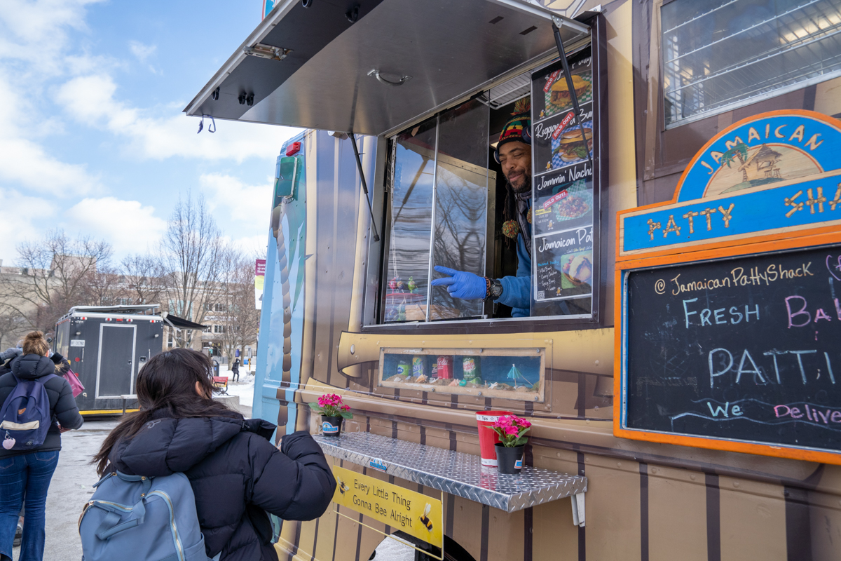 A student orders from the Jamaican Patty Shack food truck