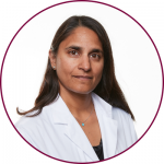 A headshot of Sonia Anand wearing a white lab coat 