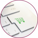 A keyboard with a button that has a green shopping cart on it 