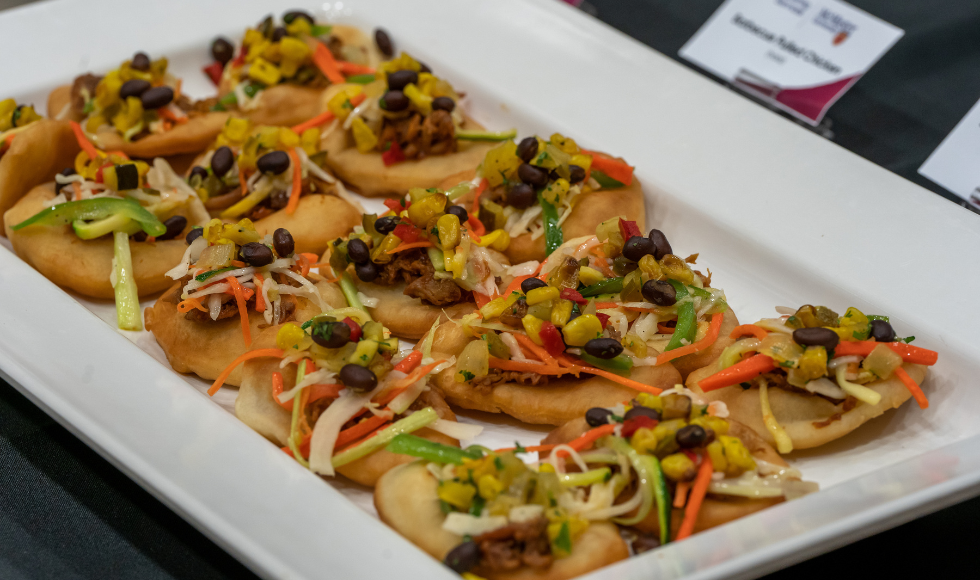 Frybread tacos laid out on a white plate 