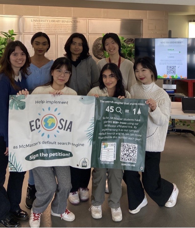 A group of students holding up a banner advertising Ecosia