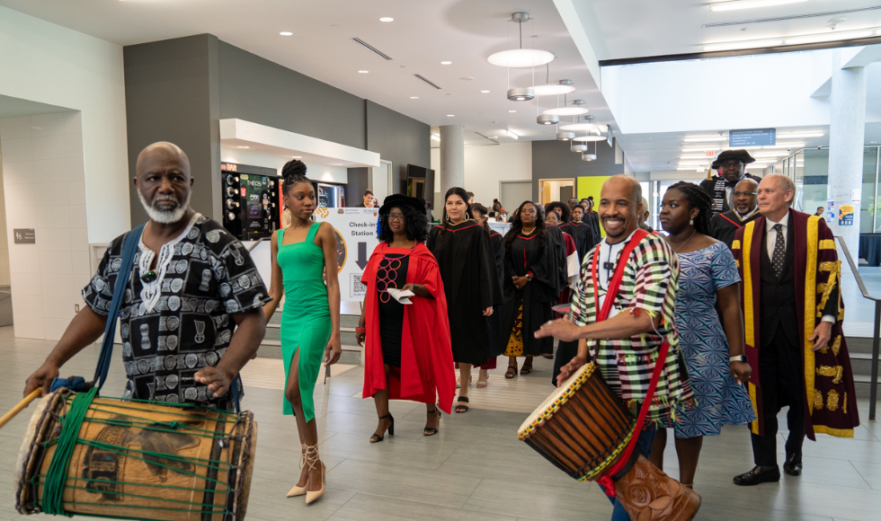 Traditional drummers lead in the academic procession through LR Wilson Hall at the Black Excellence Graduation celebration