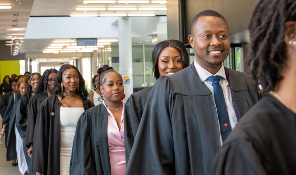 Graduating students line up to enter LR Wilson Concert Hall at the Black Excellence Graduation celebration.