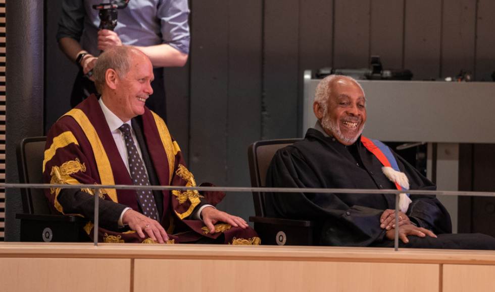 McMaster President David Farrar and Professor Emeritus Gary Warner share a laugh from their seats at the Black Excellence Graduation celebration.