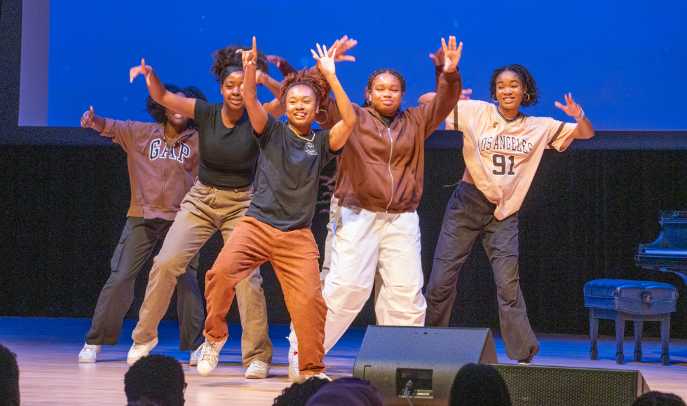 Six hip hop dancers on stage during the Good Fortune Medley dance performance at the Black Excellence Graduation celebration.