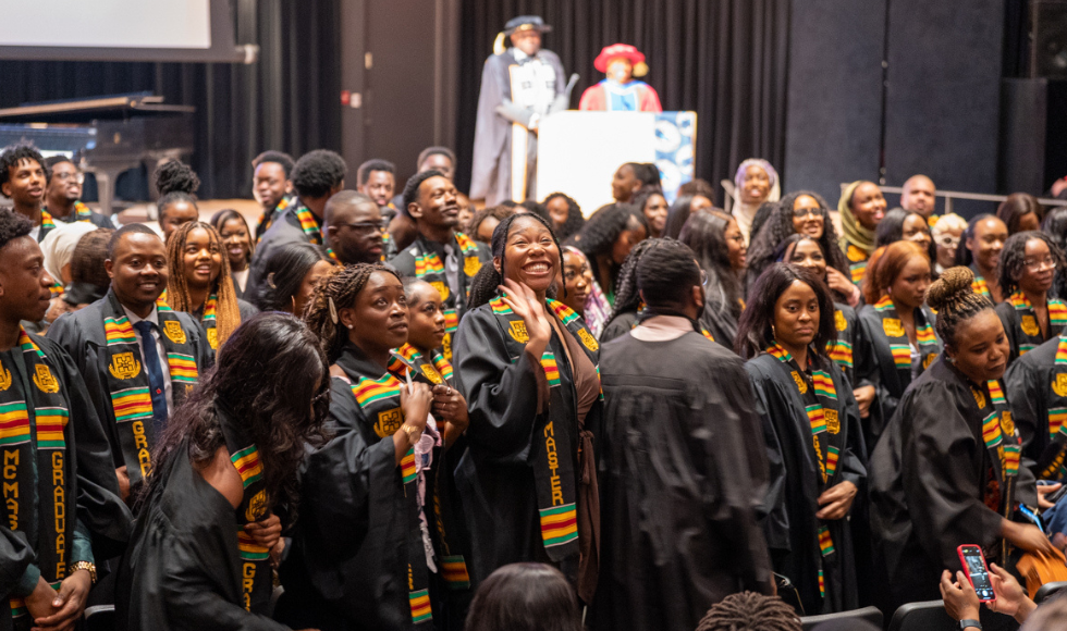 Graduating students all standing up and turned to face the audience of loved ones and wellwishers at the Black Excellence Graduation celebration.