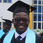 Toluwalase Dayo-Olaide wearing a mortar board and blue stole smiling at the camera
