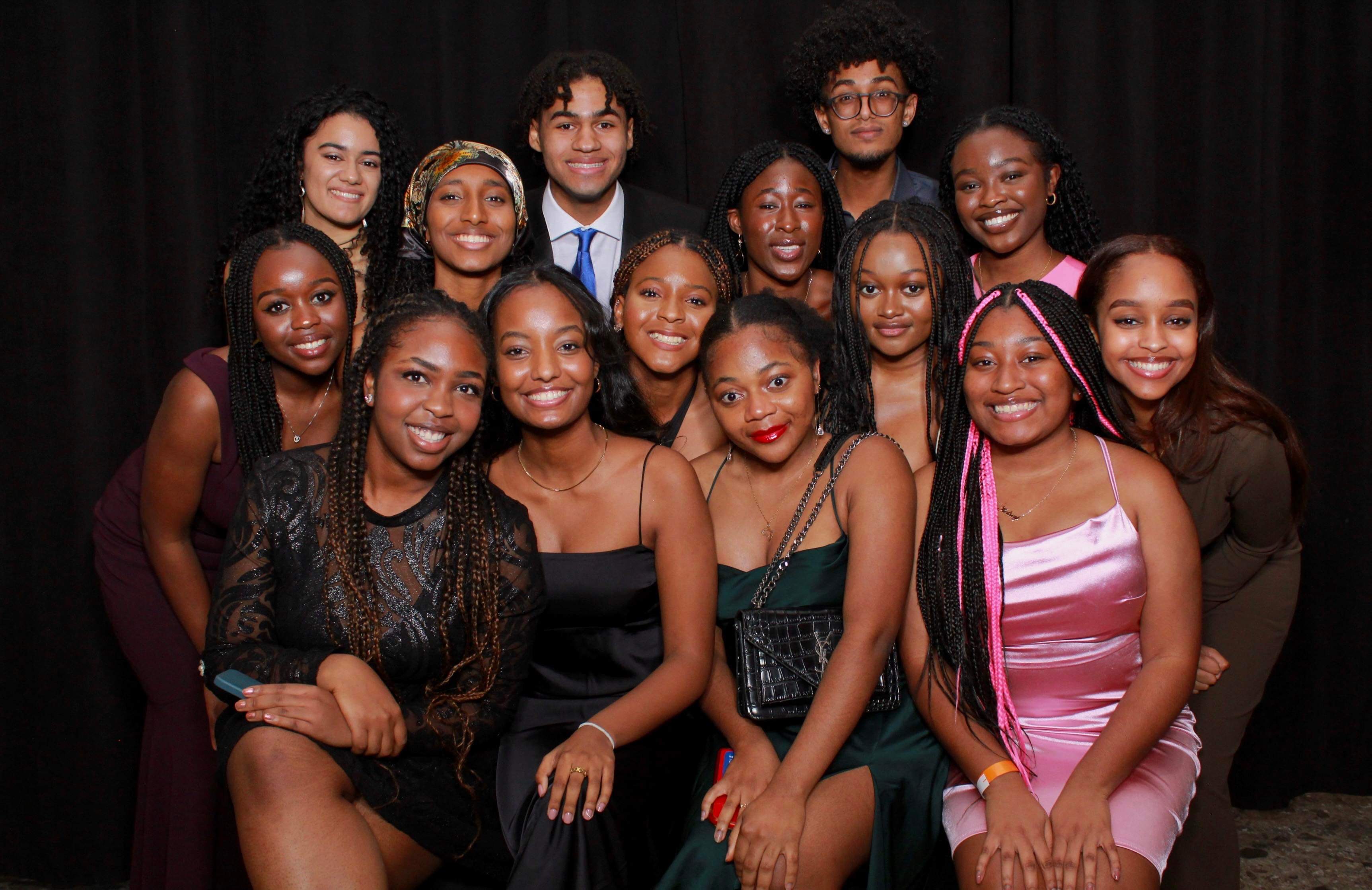 A group of McMaster students in formal wear posing for a photo