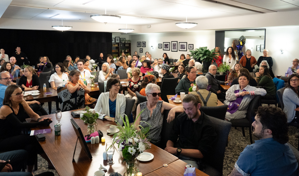 students, friends, family, faculty and staff fill the Buttery restaurant, in the lower floor of Alumni Memorial Hall, for the 2023 Indigenous Graduation celebration.