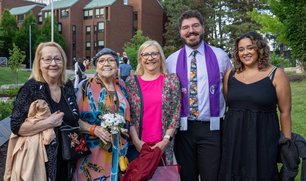 James Lemoine standing with outside with four women: Two of his aunts, his mom and his girlfriend. Everyone is smiling.