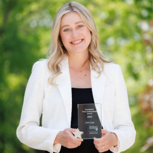 Abbie Little holding the Early Achievement Award