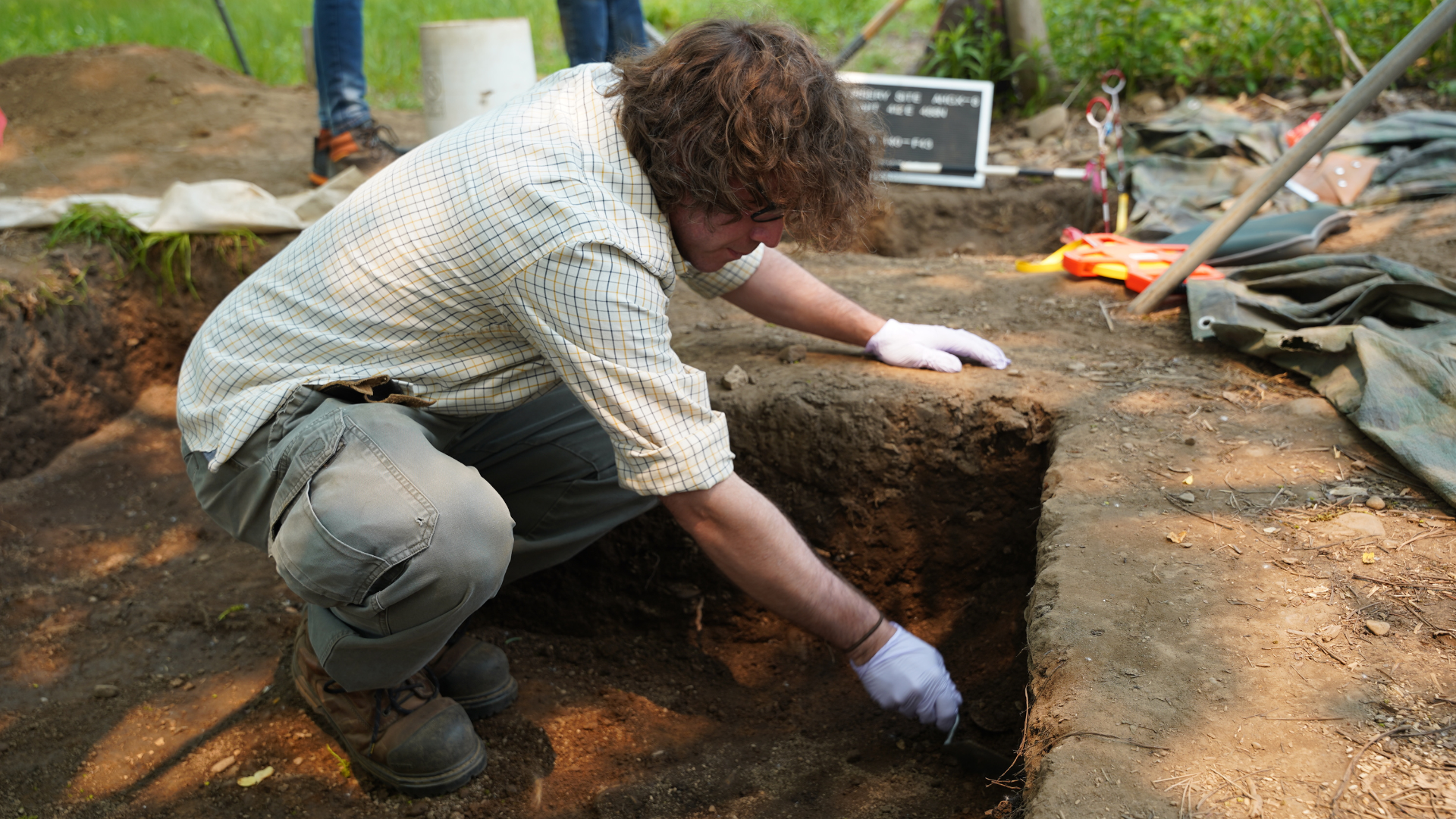 Scott Martin working in a pit an archaeological site 
