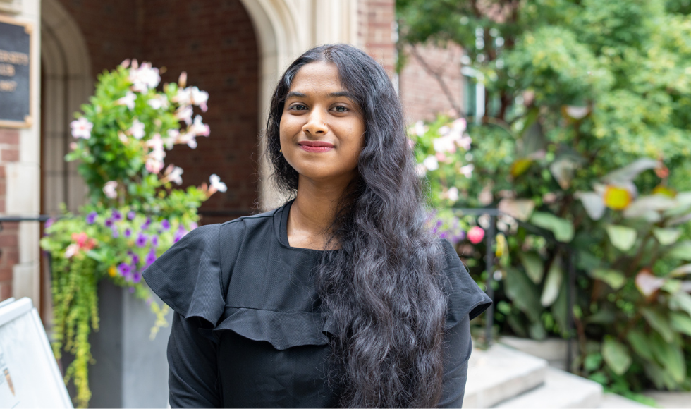 Moumita smiling at an outdoor location on campus.