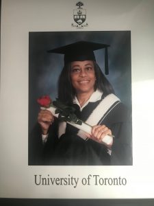 A University of Toronto graduation picture of Denise in cap and gown