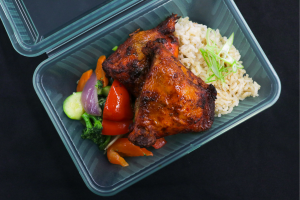 Food in a clear, green reusable container 
