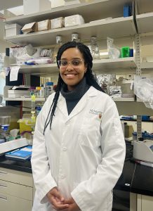 Image of Karla Martinez Pomier smiling for a picture in the research lab 