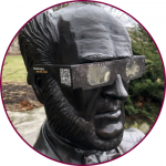 A statue of William McMaster wearing eclipse glasses