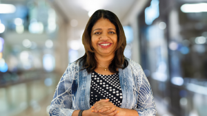 Headshot of Uma Gopinath smiling