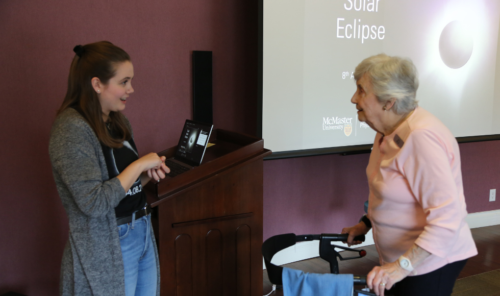 eclipse ambassador Nicole Mulyk in conversation with an older woman using a walker 