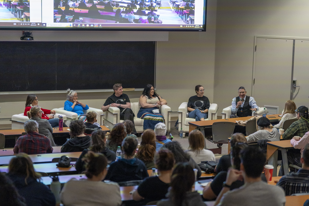 Image of a panel of people talking at an event